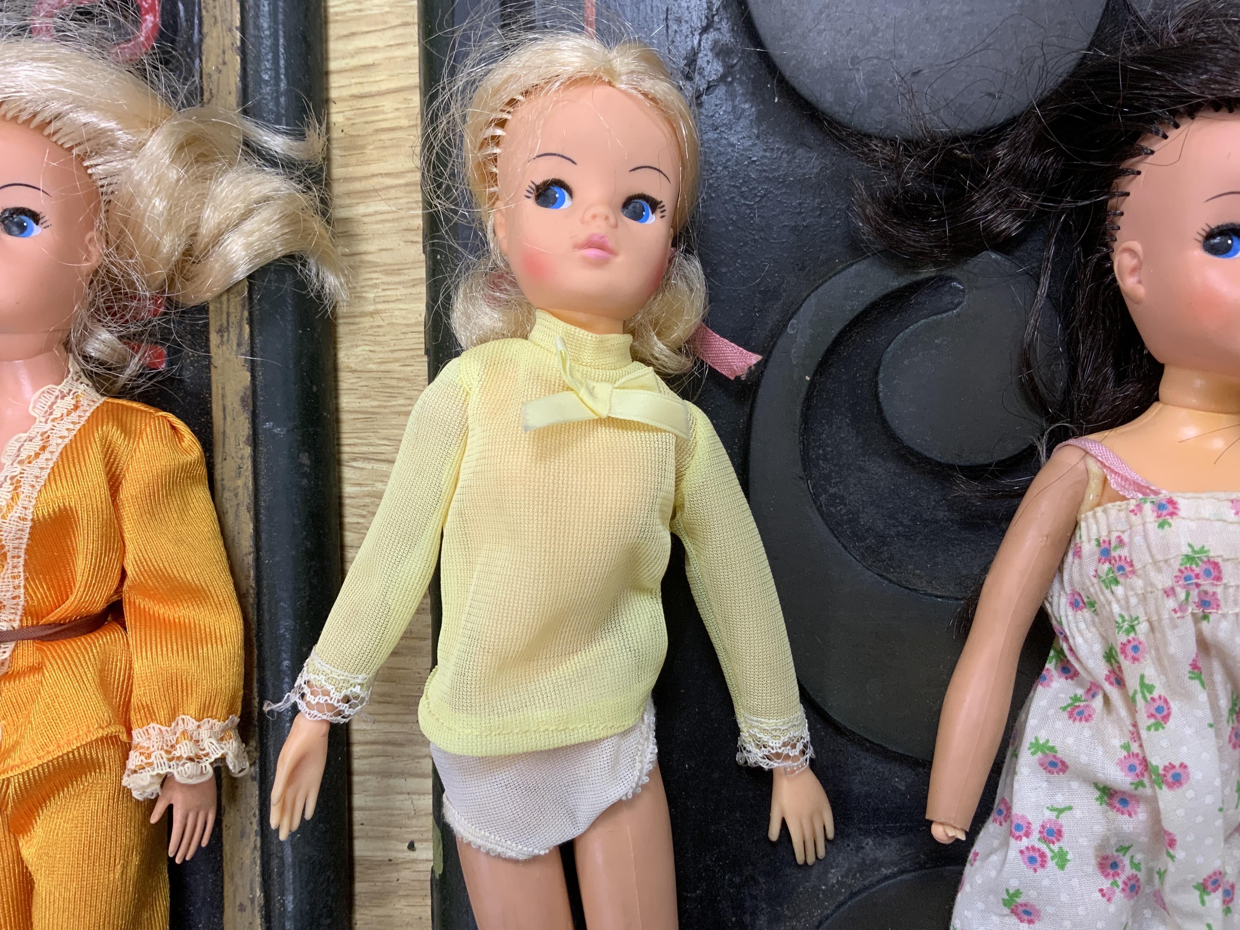 A collection of 1960s-80s Sindy dolls and accessories, including; five dolls, an early plywood and hardboard caravan, a large selection of clothing and accessories, furniture, house fittings, including a shower, wardrobe